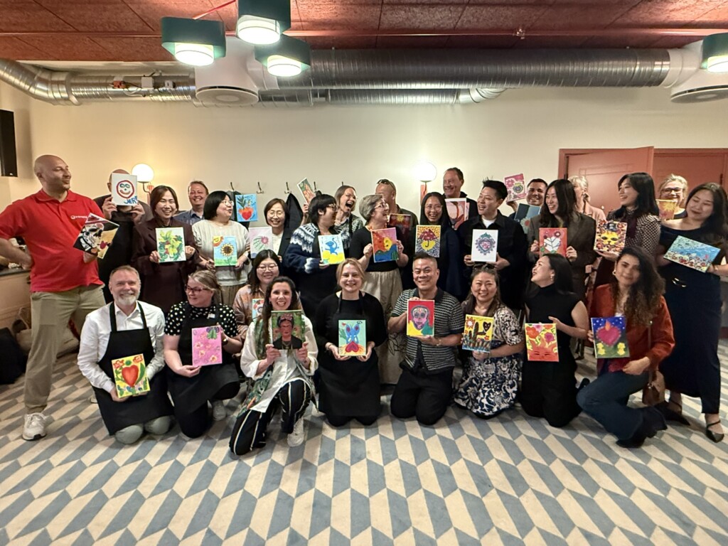 Company event at a partner venue — every guest with their finished painting