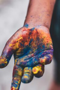 Vibrant painted hand showcasing artistic expression and creativity in vivid colors.
