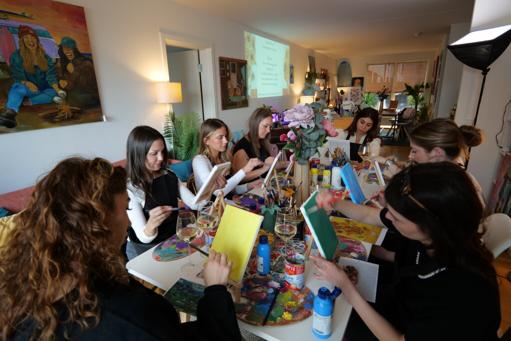 painting and wine workshop in Copenhagen private studio at Teglholmen with guests painting together at long tables